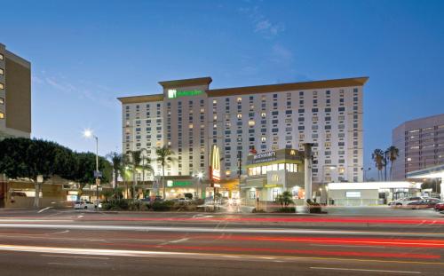 a large hotel building on a city street at night at Holiday Inn Los Angeles - LAX Airport by IHG in Los Angeles