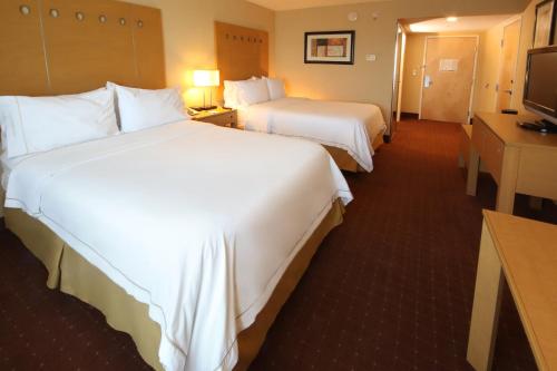 a hotel room with two beds and a television at Holiday Inn Express Hotel & Suites CD. Juarez - Las Misiones by IHG in Ciudad Juárez