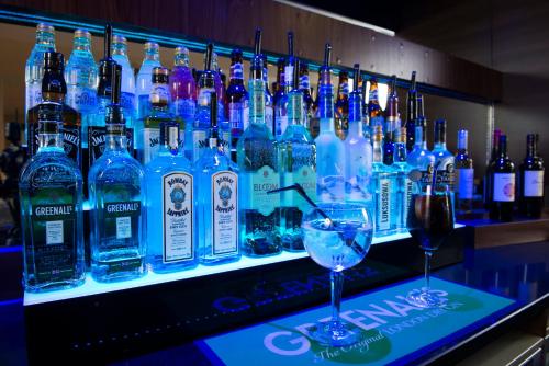 a bar with a bunch of bottles of alcohol at Holiday Inn Express Birmingham Oldbury by IHG in Oldbury