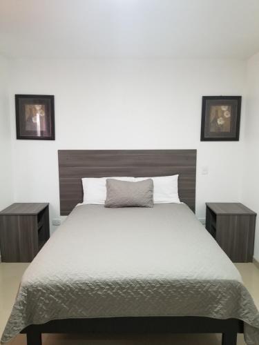 a bedroom with a large bed with two night stands at Sea Rock Hotel in Puerto Peñasco