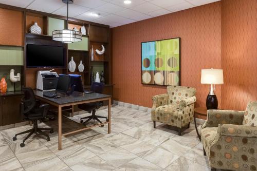 an office with a desk and two chairs and a computer at Holiday Inn Wichita East I-35 by IHG in Wichita