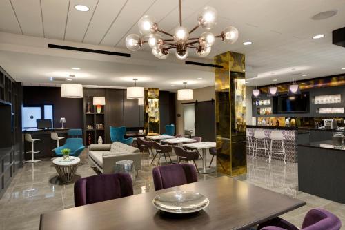a restaurant with tables and chairs and a bar at InterContinental St. Paul Riverfront by IHG in Saint Paul