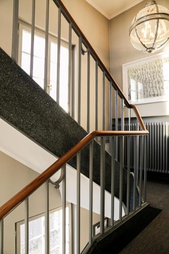 a staircase in a home with a chandelier at Hotel Hirschen am See in Meilen