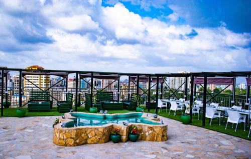 a patio with a swimming pool and tables and chairs at Holiday Inn Dar Es Salaam by IHG in Dar es Salaam