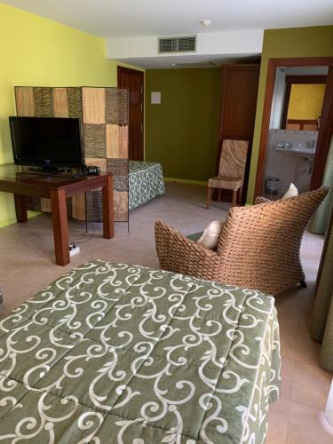 a living room with a bed and a television at Hotel Restaurant Cal Petit in Oliana