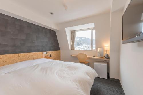 Postel nebo postele na pokoji v ubytování Nikko Station Hotel 2