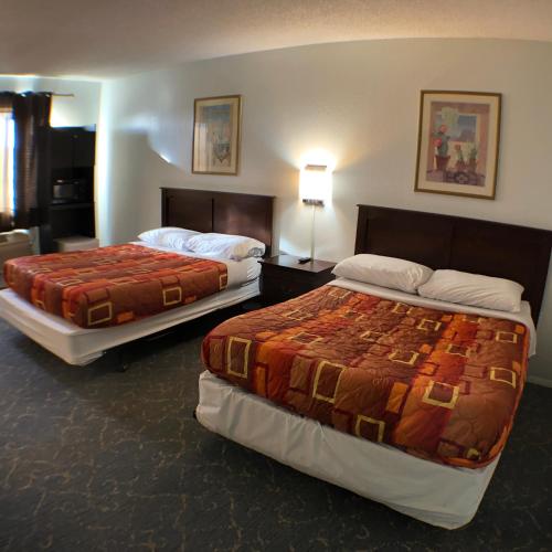 a hotel room with two beds in a room at Tower 64 Motel & RV in Trinidad