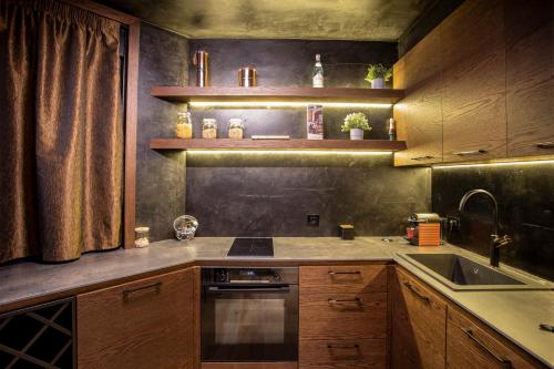 a kitchen with a sink and a stove top oven at Bella Roe Premium Apartments in Belgrade