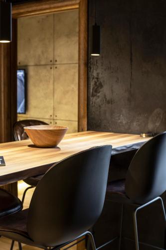 a table with chairs and a bowl on top of it at Bella Roe Premium Apartments in Belgrade
