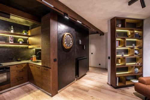 a kitchen with a large clock on the wall at Bella Roe Premium Apartments in Belgrade