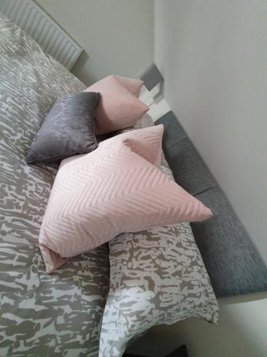 a pile of pillows sitting on top of a bed at Cong Getaway Lodge in Mayo