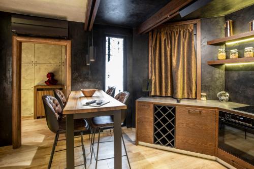 a kitchen with a table and chairs in a room at Bella Roe Premium Apartments in Belgrade