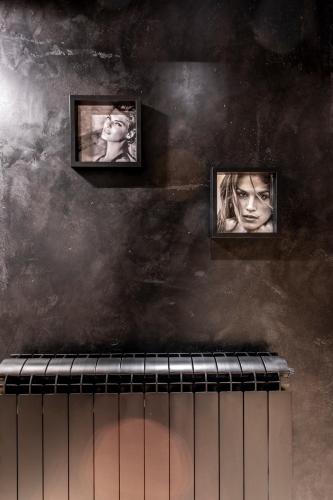 three pictures on a wall above a radiator at Bella Roe Premium Apartments in Belgrade