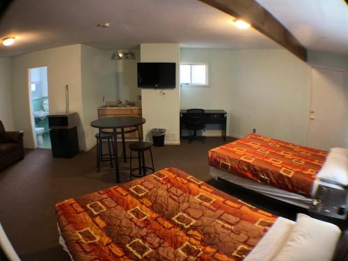 a hotel room with two beds and a table at Tower 64 Motel & RV in Trinidad