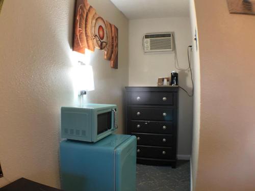 a room with a television on top of a refrigerator at Tower 64 Motel & RV in Trinidad