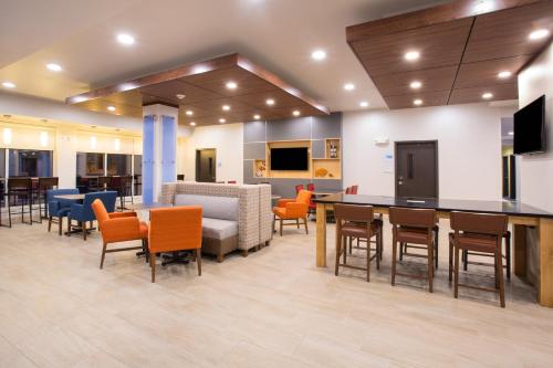 a lobby of a hospital with a bar and chairs at Holiday Inn Express & Suites - Rapid City - Rushmore South, an IHG Hotel in Rapid City