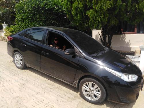 a black car with two people in the window at Stunning villa with ocean views and free car in Lamai