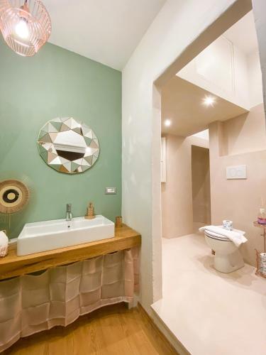 a bathroom with a sink and a toilet at OROROSA Lucca City Center Apartment in Lucca