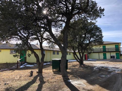 a group of trees in front of a building at Tower 64 Motel & RV in Trinidad