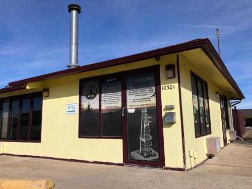 a yellow building with a tower on the door at Tower 64 Motel & RV in Trinidad