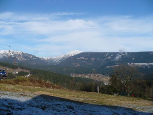 a view of a mountain range with snow covered mountains at Ubytování v soukromí Kouba in Pec pod Sněžkou