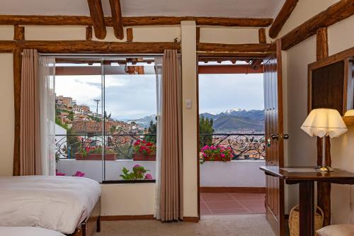 a hotel room with a bed and a window at Luna House Cusco in Cusco