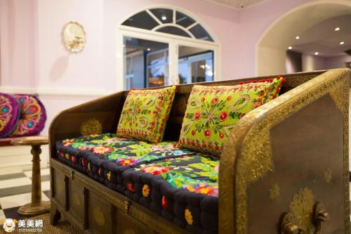 a couch with pillows on it in a room at Jinhue Hotel in Luye