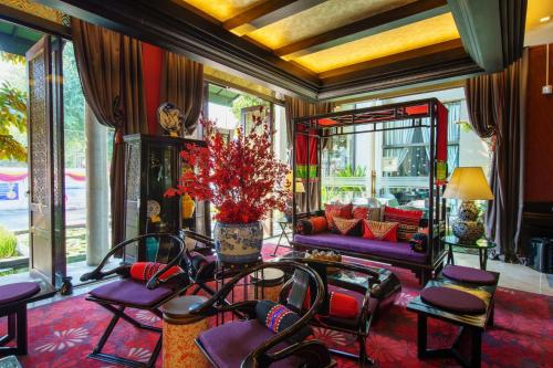 a lobby with purple and red chairs and a couch at Chala Number6 in Chiang Mai