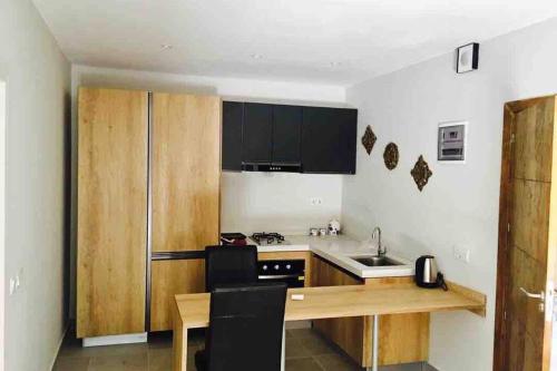 a kitchen with a wooden counter and a sink at FOREST VIEW LUXURY APARTMENT in 3mins walk to beach pool view wifi in Kololi
