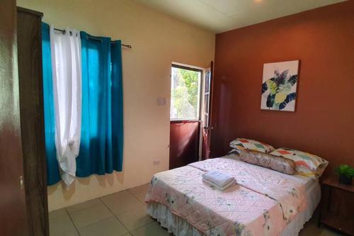 a bedroom with a bed and a window at Arabella's Home in Dumaguete