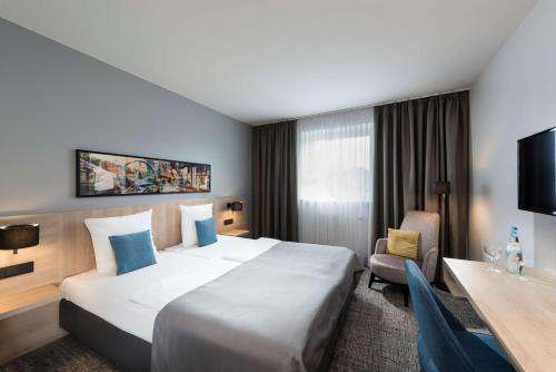Postel nebo postele na pokoji v ubytování Ramada by Wyndham Flensburg City