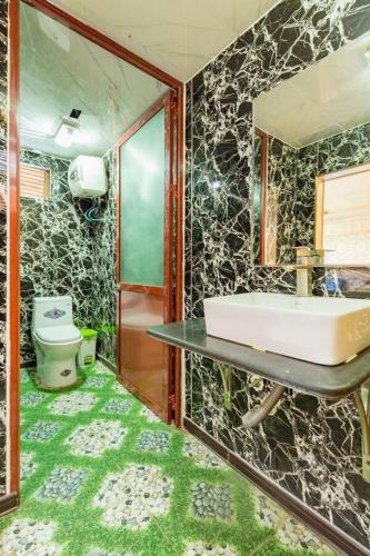 a bathroom with a sink and a toilet at Cat Ba Bay Cruises in Cat Ba
