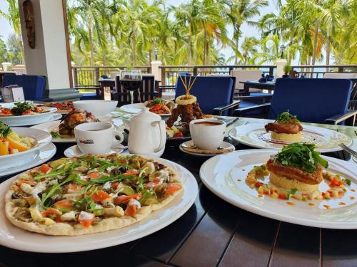 a table with plates of food on top at Banyu Biru Villa in Lagoi