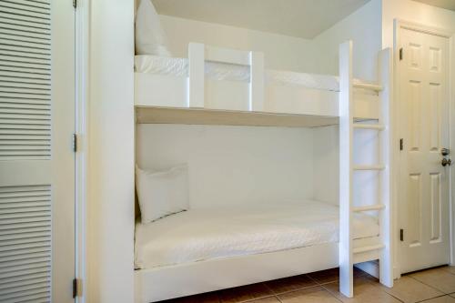 a white bunk room with white bunk beds at Seychelles Beach Resort IV in Panama City Beach