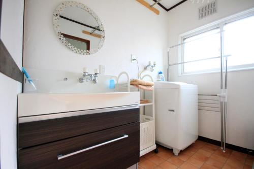 a bathroom with a sink and a shower at kODATEL コダテル 函館シーサイド in Hakodate