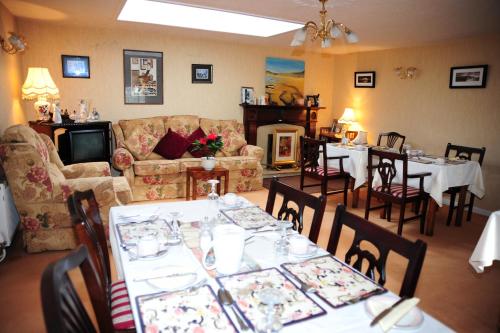 a dining room with white tables and chairs at The Mill Bar in Athlone