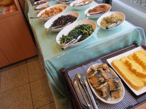 a buffet with plates of food on a table at Ace Inn Kariya in Kariya