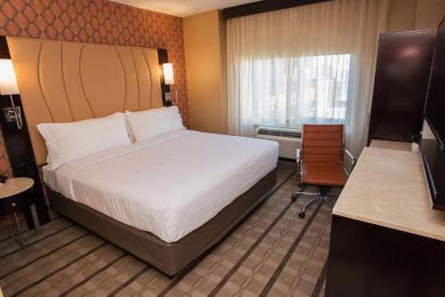 a hotel room with a bed and a window at Holiday Inn New York City - Times Square by IHG in New York