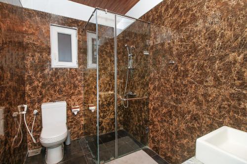 a bathroom with a shower and a toilet at Hotel 198 Negombo in Negombo
