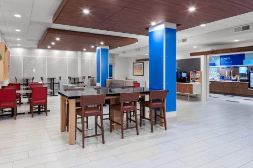 a dining room with a table and chairs at Holiday Inn Express & Suites Wilmington West - Medical Park by IHG in Wilmington