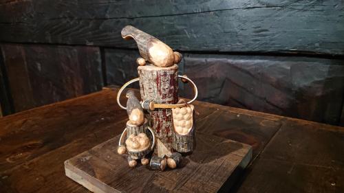 a cup with two figurines on a wooden table at みのり家 - Samurai-era house - 昔の暮らし体験 in Takayama