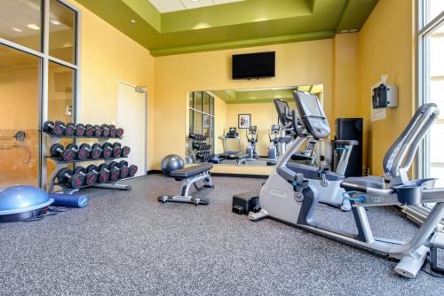 a fitness room with treadmills and cardio machines at Holiday Inn Indianapolis North-Carmel by IHG in Carmel