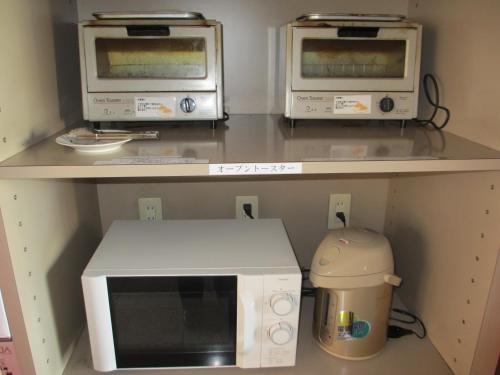 a kitchen with two microwaves on a counter at Ace Inn Kariya in Kariya