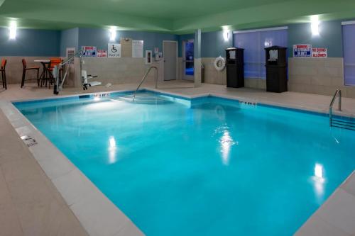 a large swimming pool with blue water at Holiday Inn Express & Suites Wilmington West - Medical Park by IHG in Wilmington