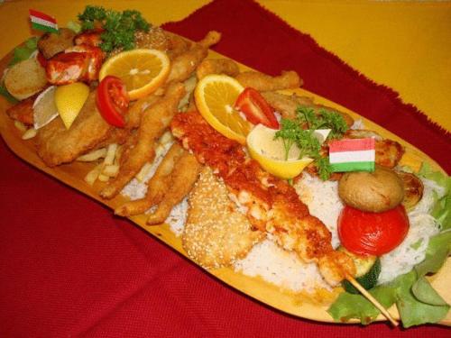 a plate of food with fish and french fries at Kis-Duna Motel & Camping in Mosonmagyaróvár