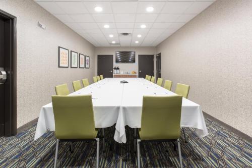 a conference room with a white table and chairs at Holiday Inn Express & Suites - Rapid City - Rushmore South by IHG in Rapid City
