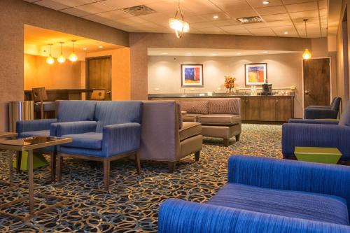 a lobby with blue chairs and a waiting room at Holiday Inn Niagara Falls State Park Entry by IHG in Niagara Falls