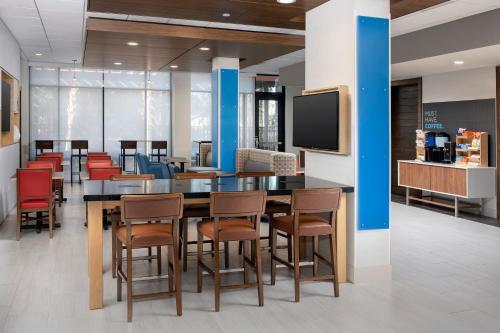 a conference room with a table and chairs and a tv at Holiday Inn Express Atlanta SW - Newnan by IHG in Newnan