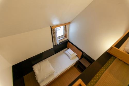 Uma cama ou camas num quarto em Niseko Ski Lodge - Hirafu