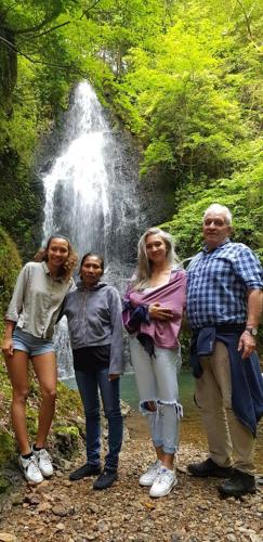 a group of people standing in front of a waterfall at Goemon Kyoto Japan in Kyoto